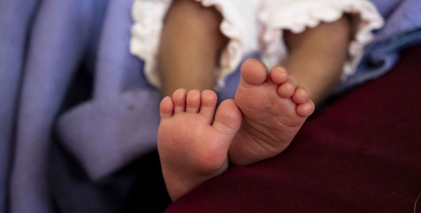 A close-up image of a newborn baby's feet.