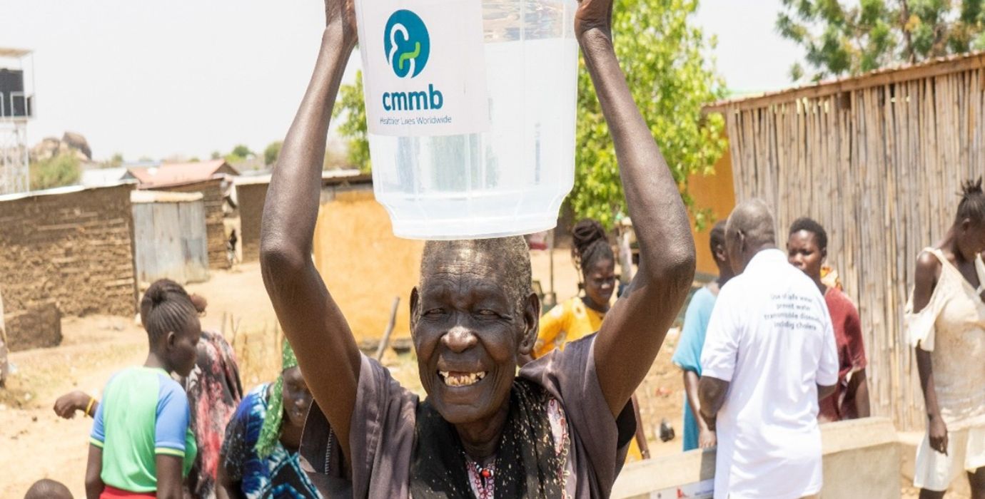 Kakau is holding a bucket of water over her head